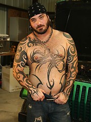 Tattooed bad boy Rock Ramsey strips down and strokes his hard dick for the camera.
