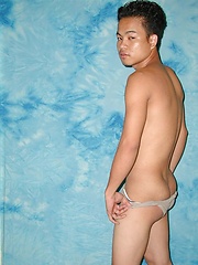 Shy asian stud posing before camera