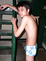 Shy asian teen boy take off his clothes