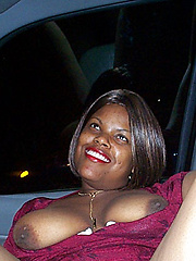 Black chick amateur posing in the car
